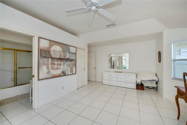 unfurnished bedroom featuring light tile patterned floors, a closet, and ceiling fan