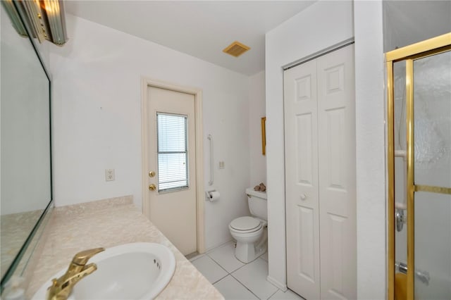 bathroom with tile patterned floors, toilet, vanity, and walk in shower