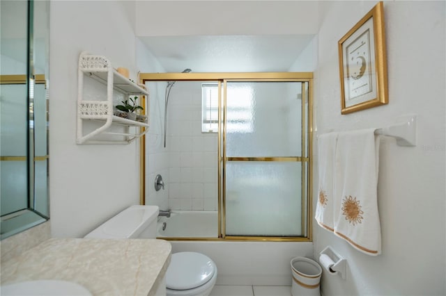 full bathroom with tile patterned flooring, vanity, enclosed tub / shower combo, and toilet