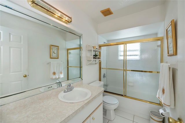 full bathroom with tile patterned floors, toilet, vanity, and combined bath / shower with glass door