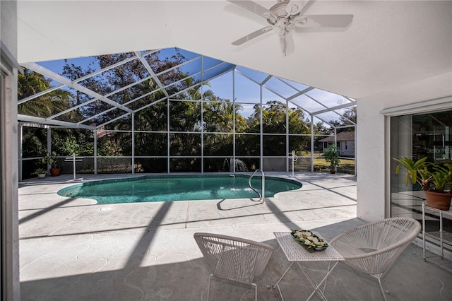 view of swimming pool with a patio, ceiling fan, and a lanai