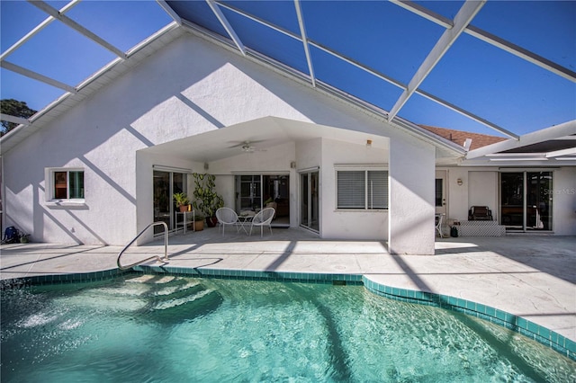 back of property featuring a patio, glass enclosure, and ceiling fan