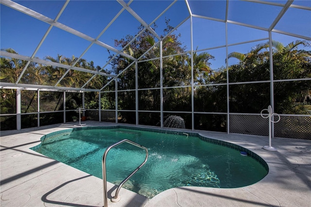 view of pool featuring glass enclosure and a patio