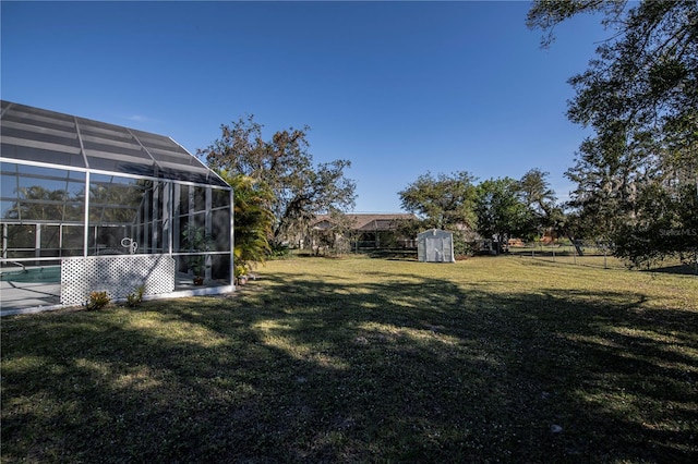 view of yard with glass enclosure and a shed