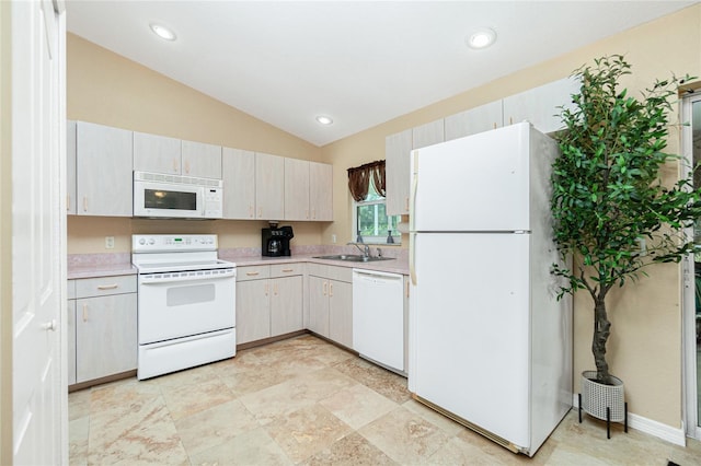 kitchen with vaulted ceiling, sink, white cabinets, and white appliances