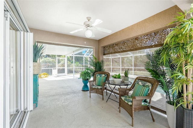 sunroom / solarium featuring ceiling fan