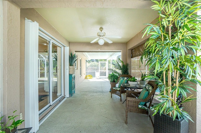 sunroom / solarium featuring ceiling fan