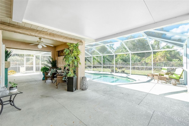 view of swimming pool with a patio, ceiling fan, and a lanai