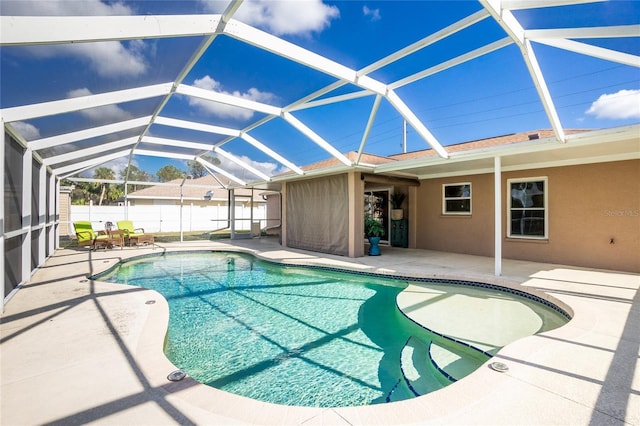 view of swimming pool with glass enclosure and a patio area