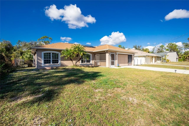 ranch-style home featuring a garage and a front lawn