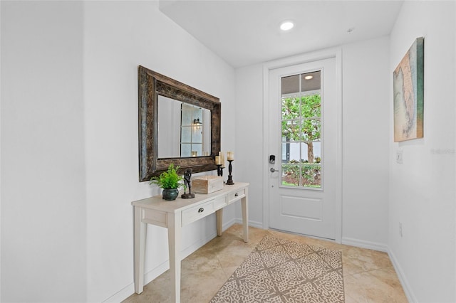 doorway to outside with light tile patterned floors