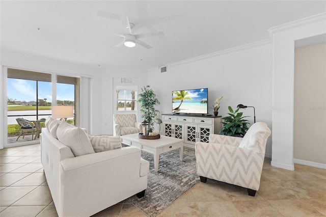 living room featuring ceiling fan, ornamental molding, and light tile patterned floors