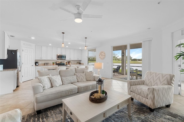 tiled living room with ceiling fan