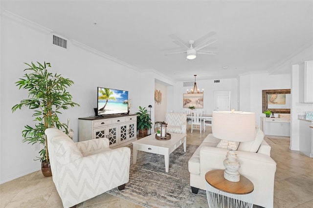 tiled living room with ceiling fan with notable chandelier and ornamental molding