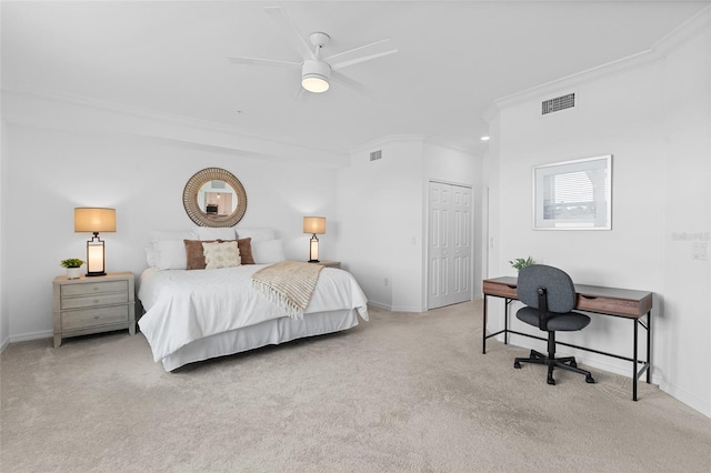 bedroom with ceiling fan, a closet, light colored carpet, and crown molding