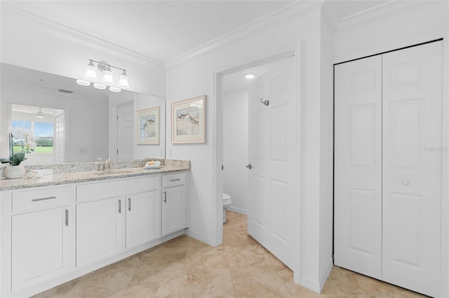 bathroom featuring vanity, tile patterned flooring, ceiling fan, toilet, and ornamental molding