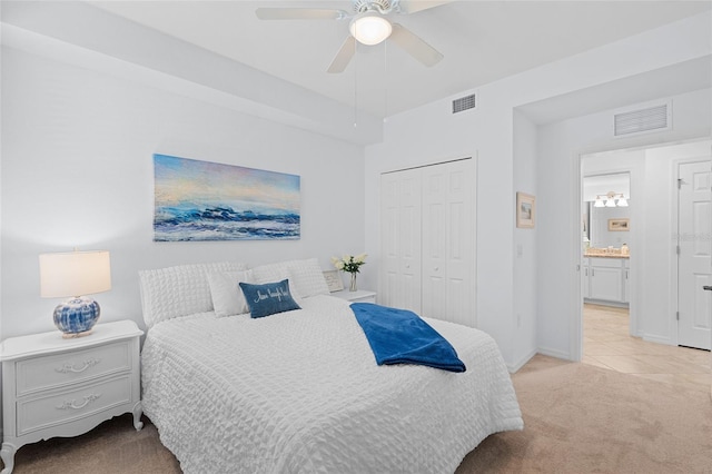 bedroom featuring ceiling fan, light carpet, and a closet