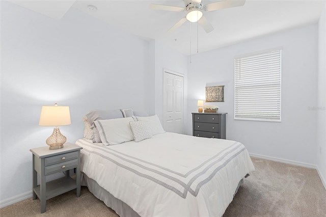 carpeted bedroom featuring ceiling fan and a closet