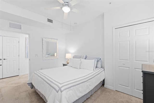 carpeted bedroom with ceiling fan and a closet