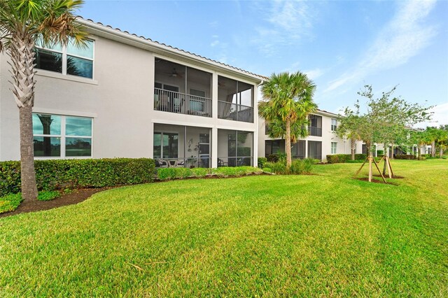 rear view of property featuring a lawn