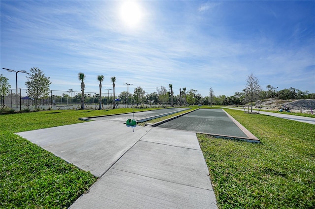 view of property's community with a lawn