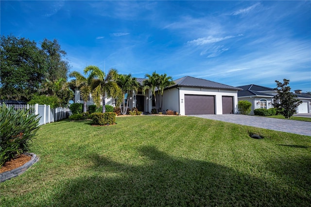 single story home with a garage and a front lawn