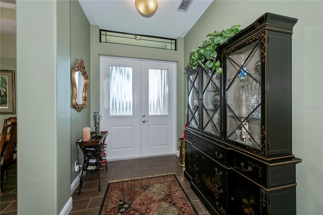 foyer entrance with french doors and lofted ceiling