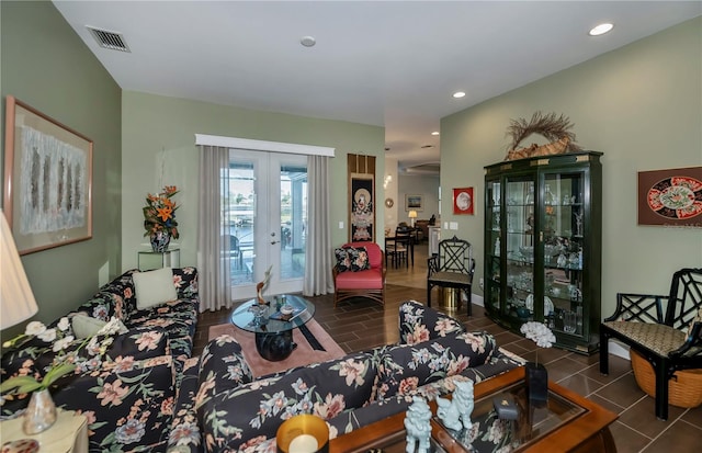 living room featuring french doors and dark tile patterned floors