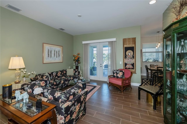 living room with dark wood-type flooring and french doors