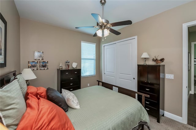 bedroom featuring ceiling fan, a closet, and carpet floors