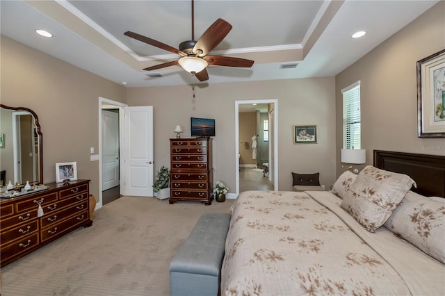 bedroom with a tray ceiling, ceiling fan, crown molding, and light colored carpet