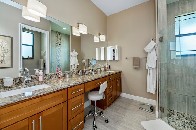 bathroom featuring vanity and a shower with shower door