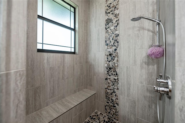 bathroom with tiled shower