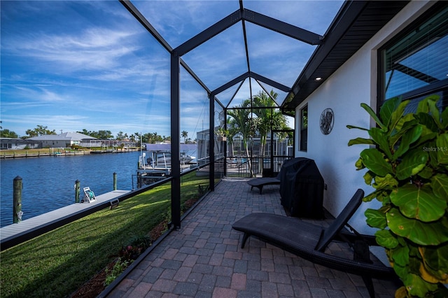 view of patio with a lanai, a boat dock, a grill, and a water view