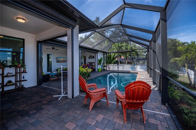 view of pool featuring ceiling fan, a patio, and glass enclosure