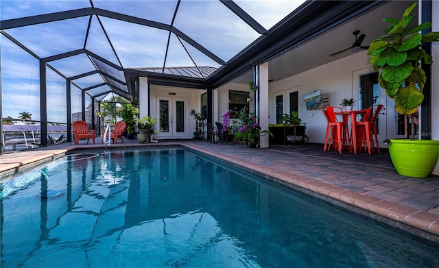 view of pool featuring french doors, glass enclosure, and a patio area