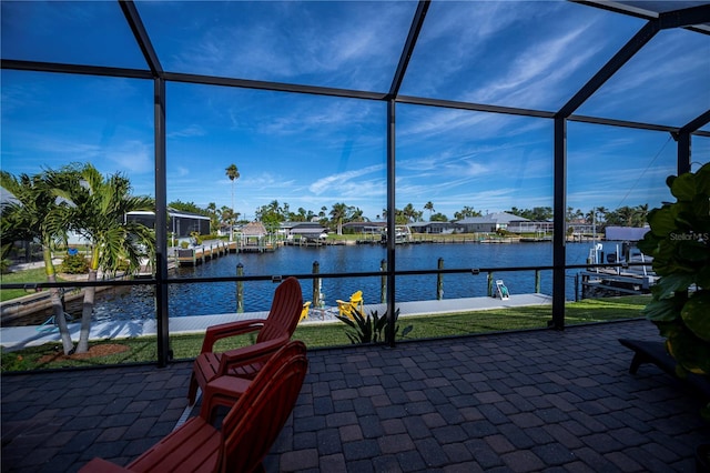 unfurnished sunroom with a water view