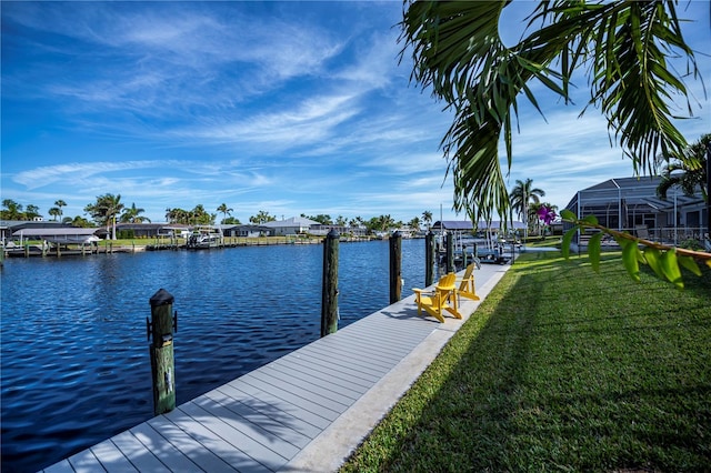 dock area featuring a water view and a yard