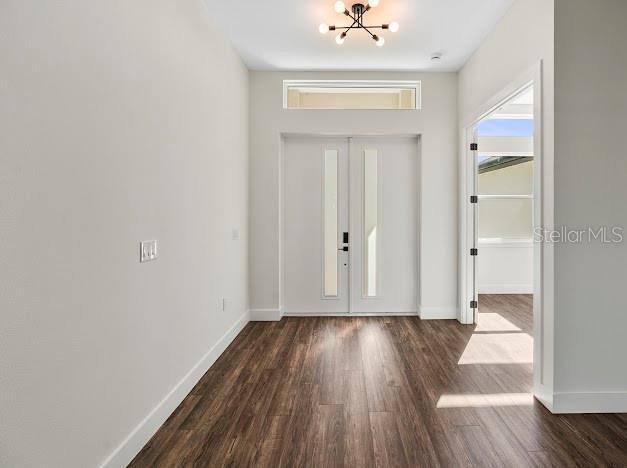 4301 Marcella Ter, North Port, FL 34286 - foyer with a chandelier and dark wood-style floors