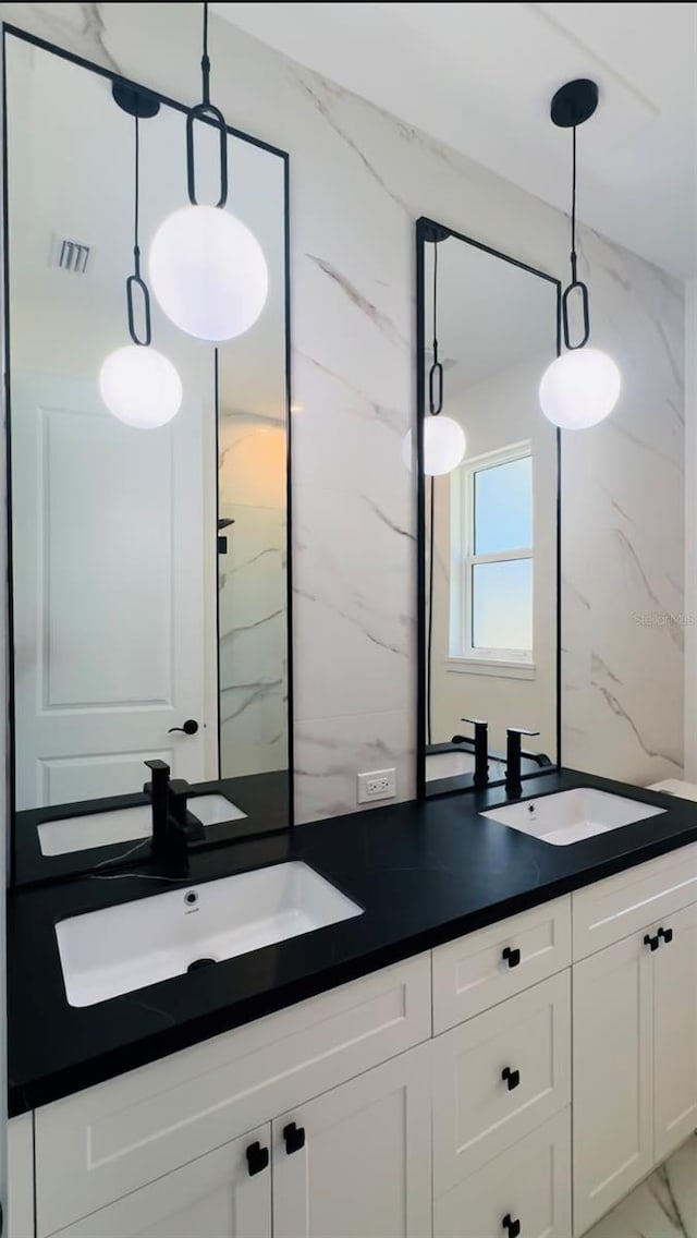 bathroom featuring vanity, walk in shower, and tasteful backsplash