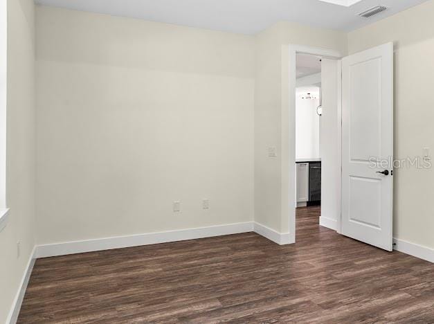 spare room featuring dark hardwood / wood-style flooring