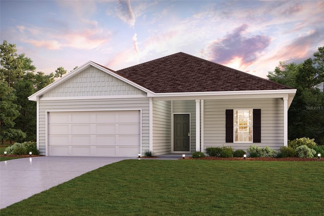 view of front facade with a yard and a garage