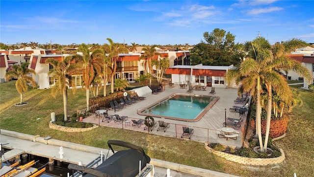 view of pool with a boat dock and a patio