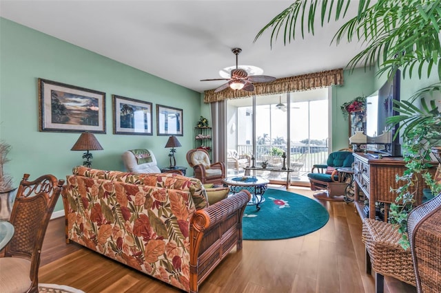 living room with hardwood / wood-style flooring and ceiling fan