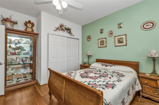 bedroom with ceiling fan, a closet, and hardwood / wood-style flooring