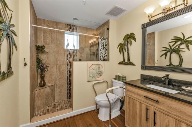 bathroom featuring a shower with curtain, toilet, vanity, and hardwood / wood-style flooring