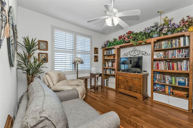 living room with ceiling fan and dark wood-type flooring