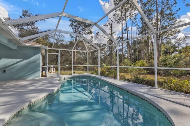 view of pool featuring a patio area and glass enclosure