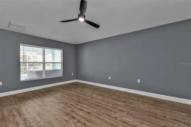 empty room with hardwood / wood-style flooring and ceiling fan