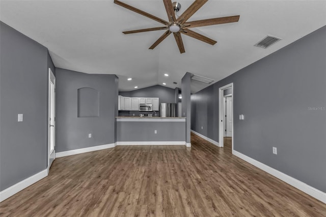 unfurnished living room featuring lofted ceiling, hardwood / wood-style flooring, and ceiling fan